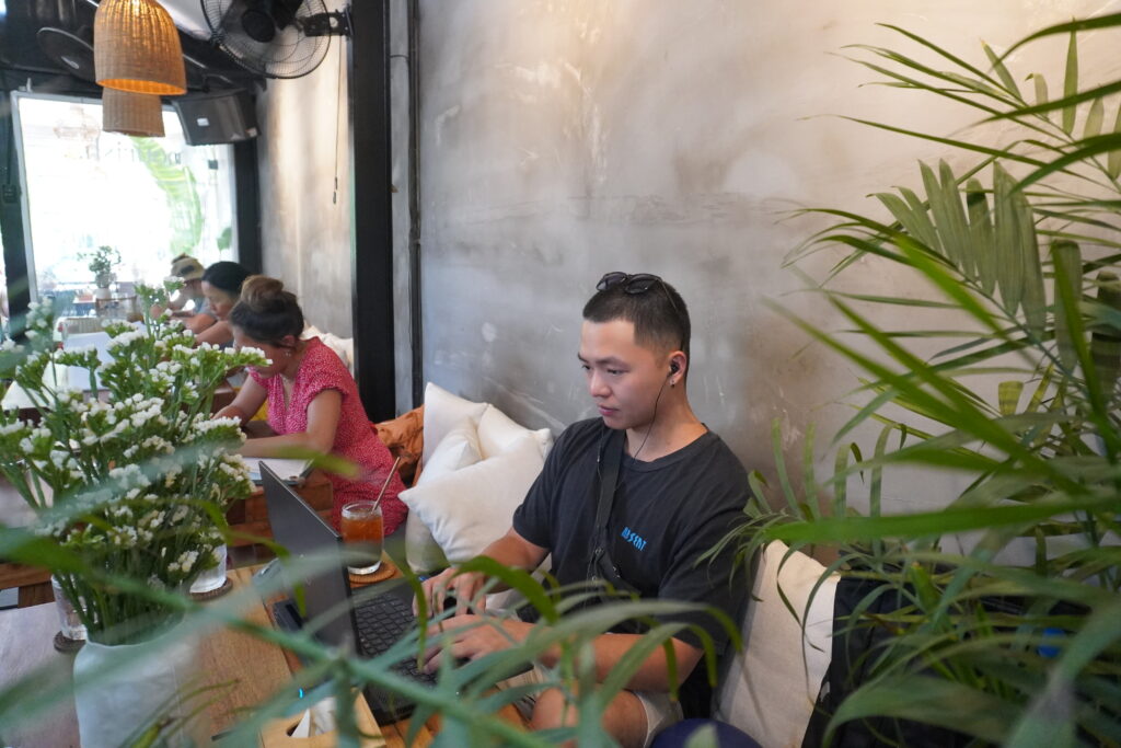 man working remotely in nourish eatery with laptop